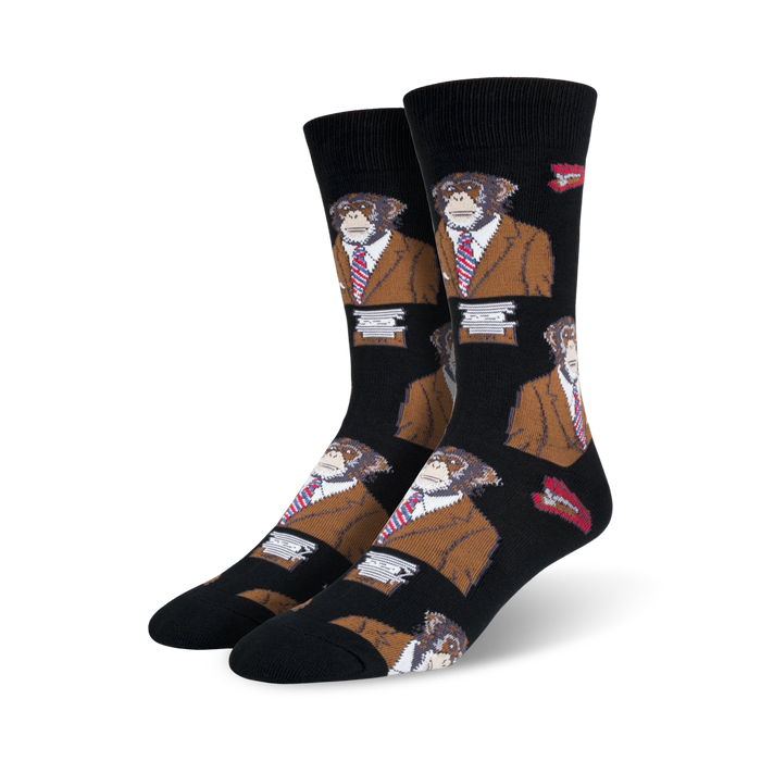 A pair of black crew socks with a repeating pattern of monkeys wearing brown suits and red ties. Small red lips are also part of the design. }}