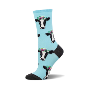 Crew socks featuring a light blue background and repeated pattern of black and white cows wearing flower crowns.