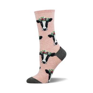 socks that are pink with a pattern of black and white cow faces. the cows are wearing flower crowns.