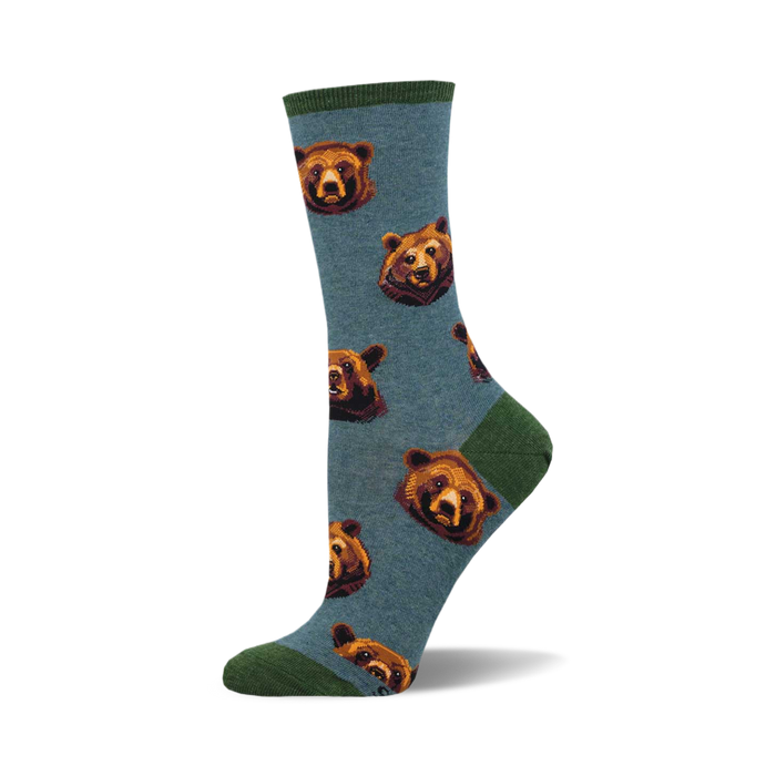 A pair of teal crew socks with a repeating pattern of brown bear faces. The socks have a green cuff. }}