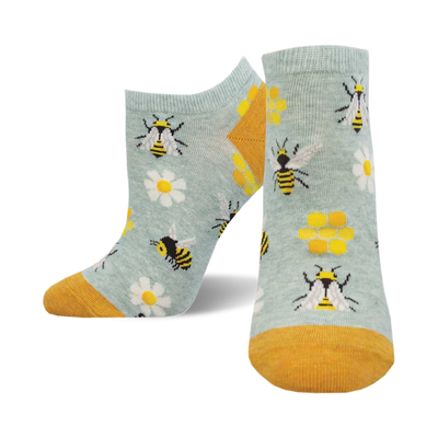 A pair of light blue ankle socks with a fun bee design.  Yellow bees, daisies, and honeycombs are featured on the socks, which have a mustard yellow cuff.