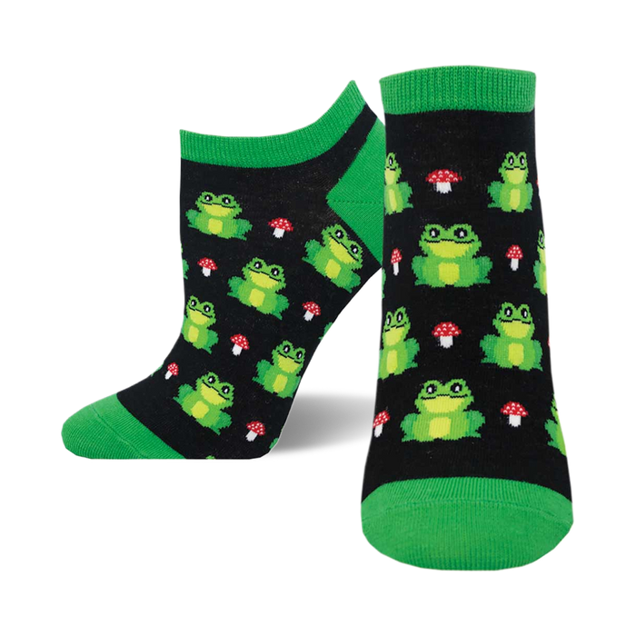 A pair of black ankle socks with a whimsical pattern of green frogs and red mushrooms. The socks have bright green cuffs. }}