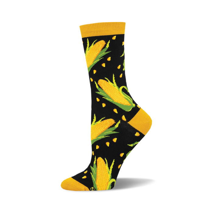socks that are black with a pattern of yellow corn. the corn has green husks. }}