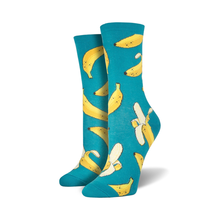 Pair of teal crew socks with a fun all-over print of yellow bananas and peeled banana slices. }}