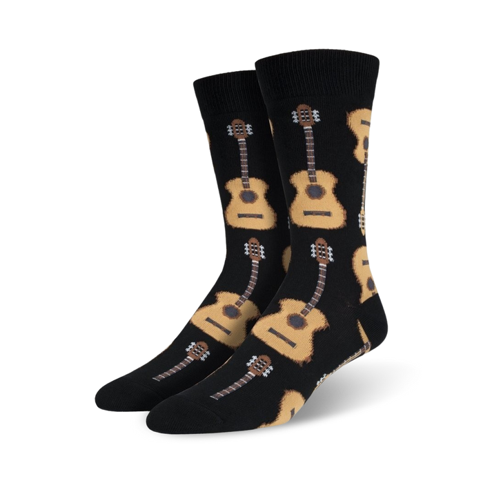 Pair of crew socks with a repeating pattern of acoustic guitars in beige and brown on a black background.