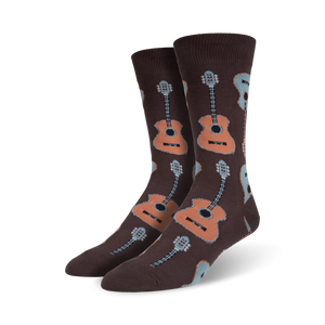 Lifestyle shot: Model wearing brown crew socks with a pattern of light brown and blue guitars.