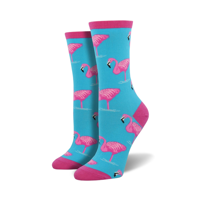 Pair of women's crew socks in teal with a pink flamingo pattern. Pink cuffs.