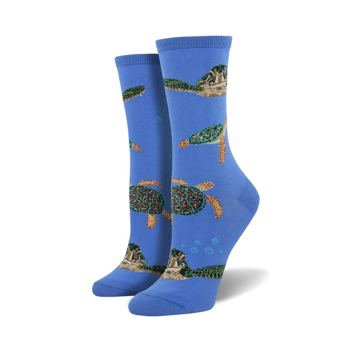 blue crew socks with a pattern of green sea turtles swimming diagonally up the sock. women's.   }}