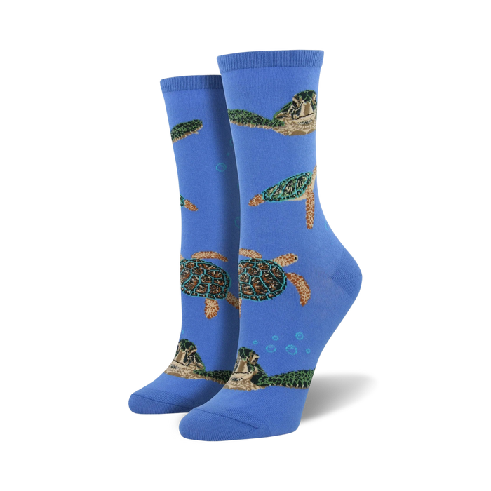 A pair of women's crew socks in blue, featuring a pattern of sea turtles swimming amongst bubbles. The turtles are green, brown, and beige. }}