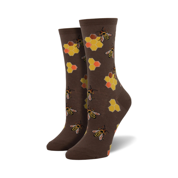 Pair of crew socks in brown and mint green. Design features busy bees and honeycombs.