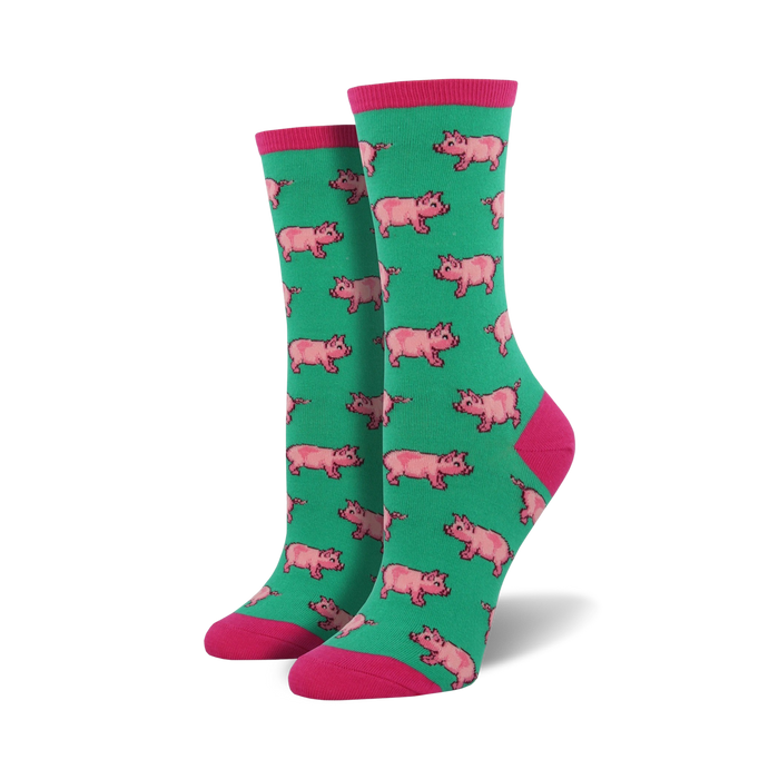 Pair of crew socks in teal with a repeating pattern of pink pigs. Pink cuffs. }}