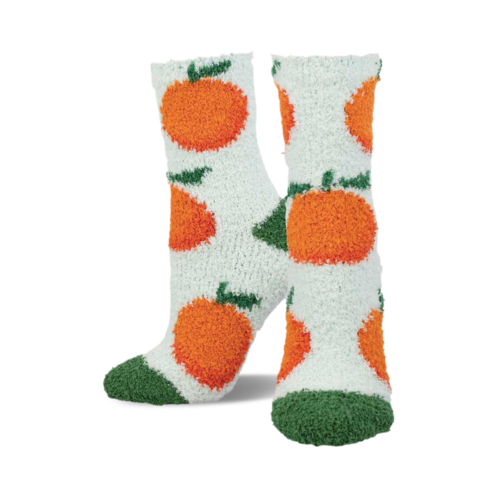 Pair of fuzzy crew socks in white with orange fuzzy oranges and green leaves.  Toes are dark green fuzzy. }}