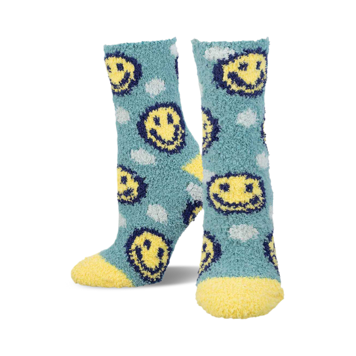 Pair of teal fuzzy socks with yellow smiley faces and white cloud accents.  Yellow fuzzy cuffs. }}