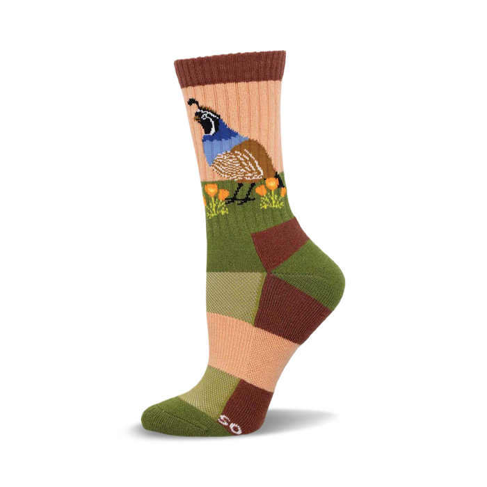 Close-up of a woman's crew sock. The sock features a colorful patchwork design in muted greens, browns, and peach, and an illustration of a quail among poppies. }}