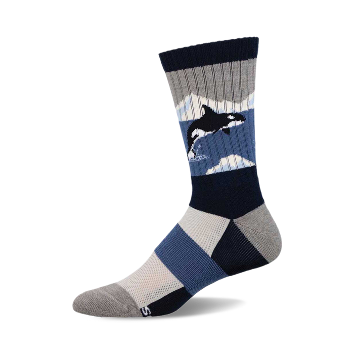 Crew socks showcasing an orca whale amid icy blue and gray geometric patterns. Features a navy blue, gray, and light blue color scheme. }}