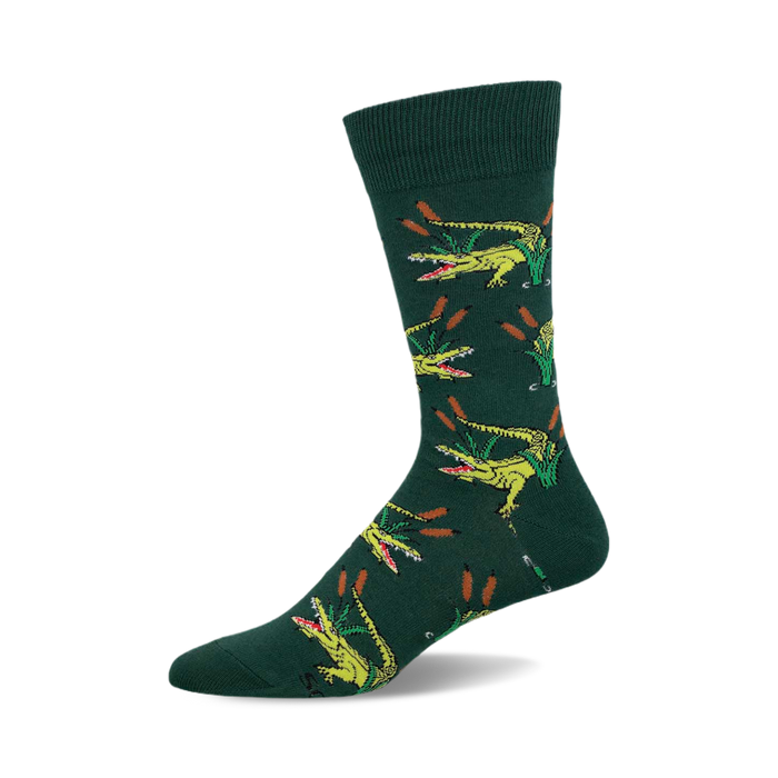 Crew socks in hunter green with a repeating pattern of yellow alligators emerging from green reeds. }}