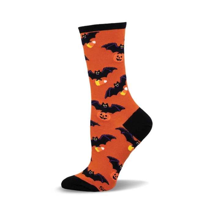 Orange crew socks with black bats and candy corn. A fun, Halloween-themed design. }}