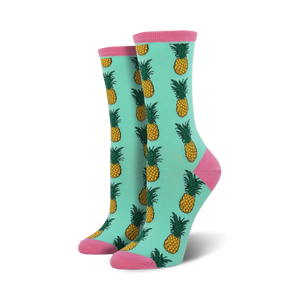 Pair of women's crew socks in teal with a repeating pineapple pattern.  Pink accents at the top and bottom.