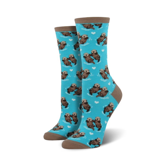 Pair of crew socks with a teal background featuring a repeating pattern of otters holding hands and small hearts.