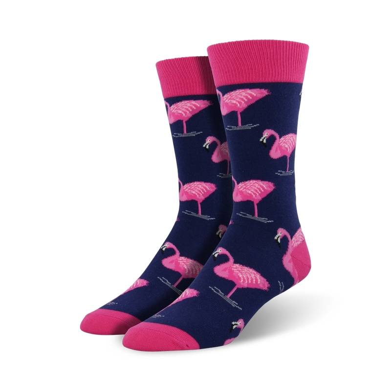 Pair of navy blue crew socks featuring a pink flamingo pattern. Pink cuffs add a pop of color. Fun and stylish!