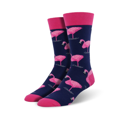 Pair of navy blue crew socks featuring a pink flamingo pattern. Pink cuffs add a pop of color. Fun and stylish!
