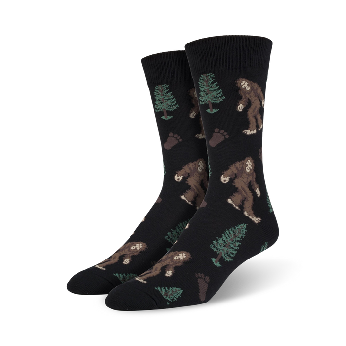 black crew socks with brown and green bigfoot and footprint pattern and pine trees. xl for men.  