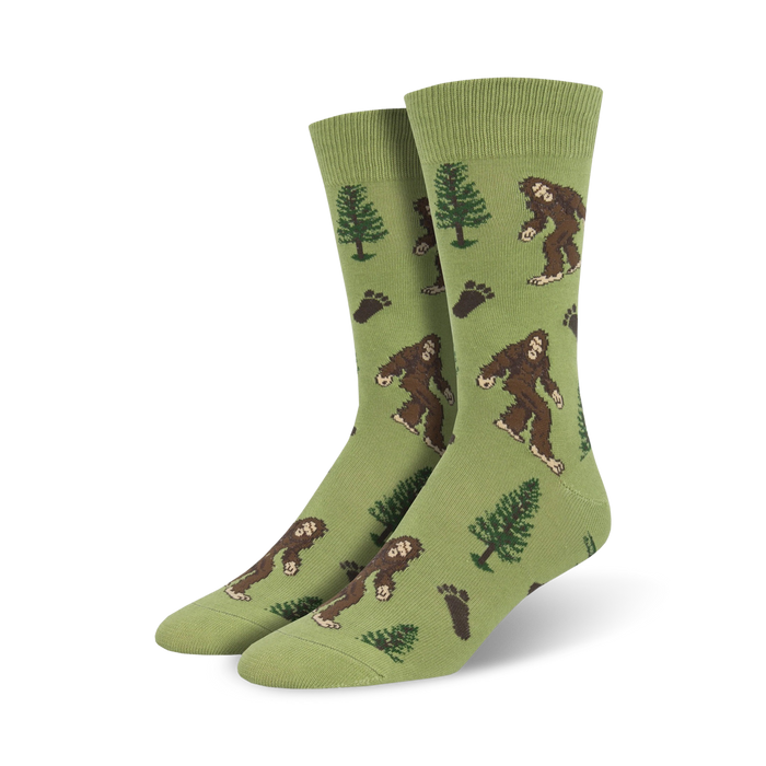 bigfoot xl crew socks in green with pattern of bigfoot, pine trees, and footprints. made for men from soft cotton blend. 