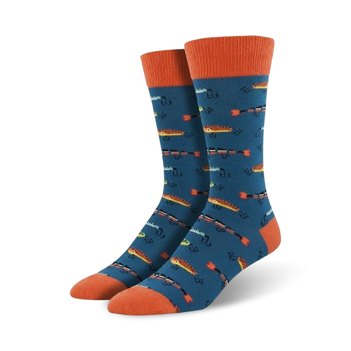mens crew socks in electric blue with all-over pattern of orange fish & fish hooks. heel and toe cap are orange.    }}