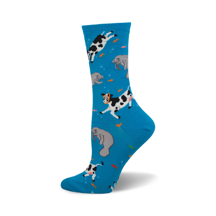 Crew socks in bright blue with a whimsical design of black and white cows and gray manatees swimming amongst orange fish. }}