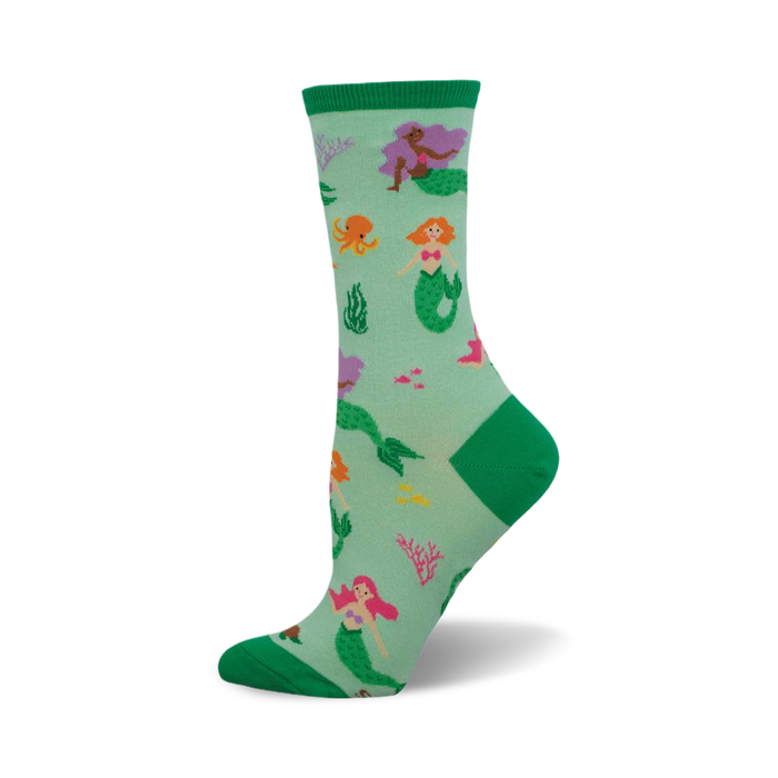 Crew socks in teal green with colorful mermaids, octopus, and coral. Green cuffs add a pop of color. }}