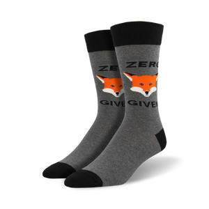 Pair of grey crew socks with black cuffs. Features a repeating design of orange fox faces and the text