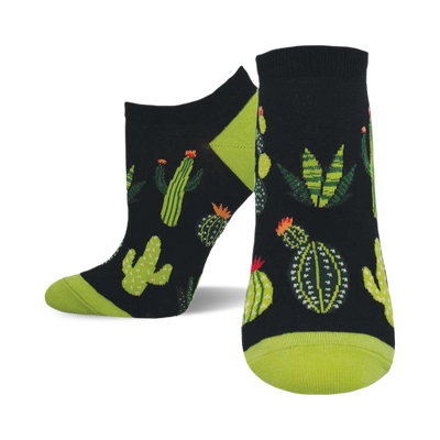 A pair of ankle socks with a black background and a fun pattern of various cacti and succulents in shades of green. The socks have lime green heels and toes.