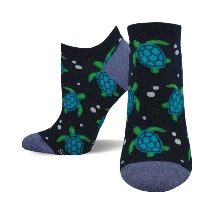 A pair of navy blue ankle socks adorned with a playful pattern of teal and green sea turtles and white dots. }}