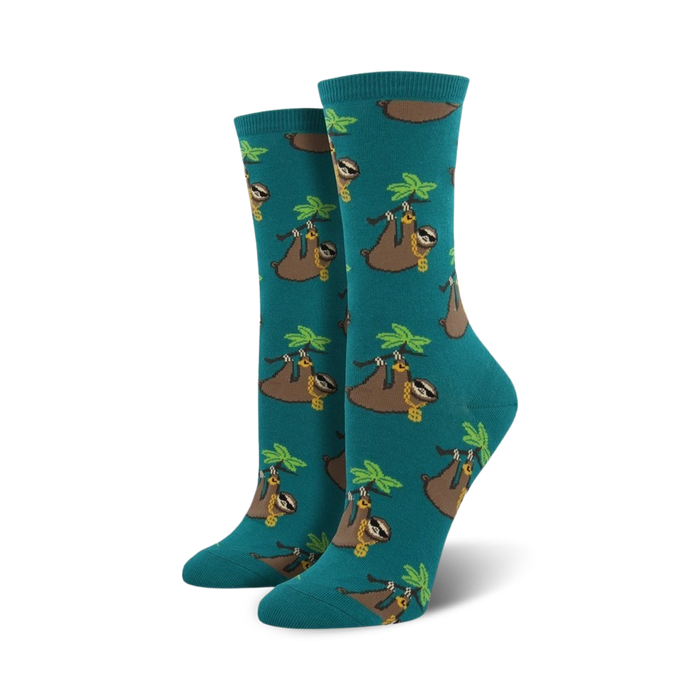Pair of teal crew socks with a pattern of sloths wearing gold chains and hanging from palm fronds.  }}