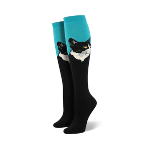 Pair of women's knee-high socks.  Black and white cat portrait on teal and red sections.  Black lower portion of socks.