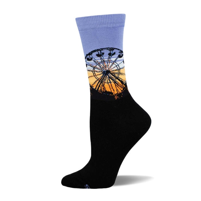 Crew sock with a black foot and a lilac cuff, featuring a Ferris wheel silhouette against an orange and blue sunrise sky. }}