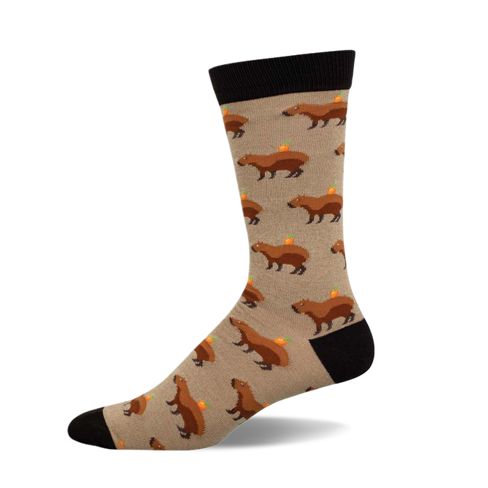 Crew socks showcasing a beige background with repeating illustrations of brown capybaras carrying small oranges. }}