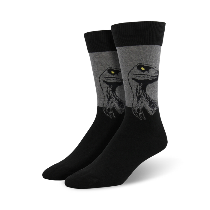 Pair of men's crew socks. Black and gray color scheme. Features a graphic of a Velociraptor's face. }}