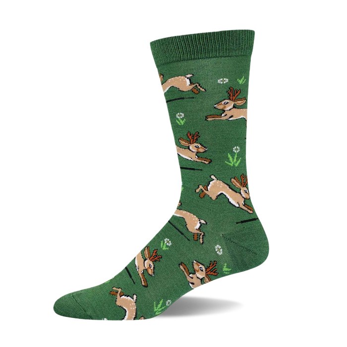 Green crew socks with a whimsical pattern of brown jackalopes hopping across a field of small white flowers and green grass. }}