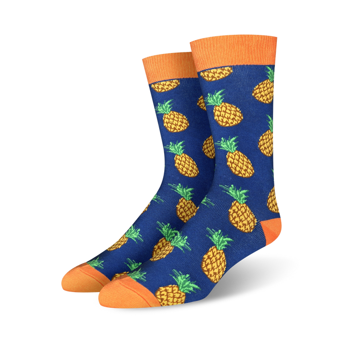 A pair of blue crew socks with a repeating pattern of yellow pineapples. The socks have orange cuffs. }}