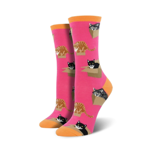 Pair of women's crew socks. Hot pink background with repeating pattern of cats in cardboard boxes. Orange-toned cuffs.
