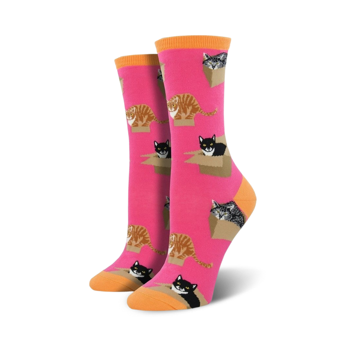 Pair of women's crew socks. Hot pink background with repeating pattern of cats in cardboard boxes. Orange-toned cuffs.