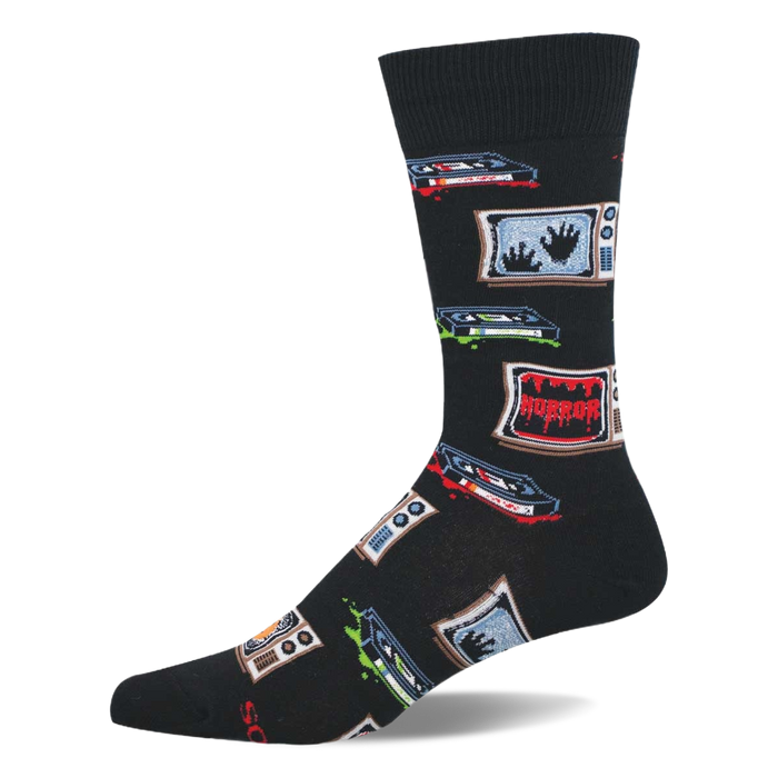 Single black crew sock featuring a pattern of vintage TVs showing ghostly hands and 'HORROR' text, with scattered VHS tapes and drips. }}