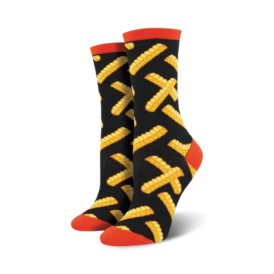 Pair of women's crew socks with a black background and a pattern of yellow french fries. The socks have orange cuffs.