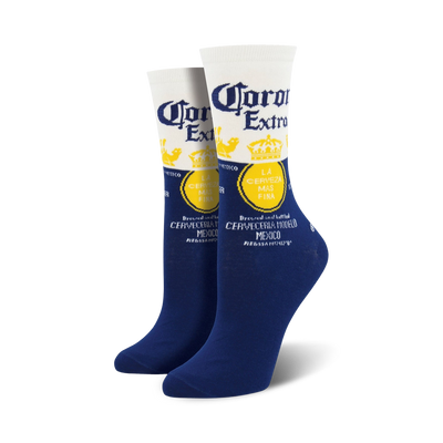 Pair of crew socks showcasing the Corona Extra beer label. The socks are predominantly navy blue with white and yellow accents.