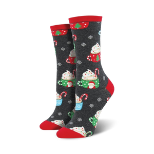 Pair of women's crew socks in dark gray with a festive design of hot cocoa cups, candy canes, and snowflakes. Red and green accents.