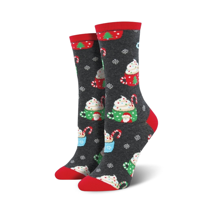 Pair of women's crew socks in dark gray with a festive design of hot cocoa cups, candy canes, and snowflakes. Red and green accents.