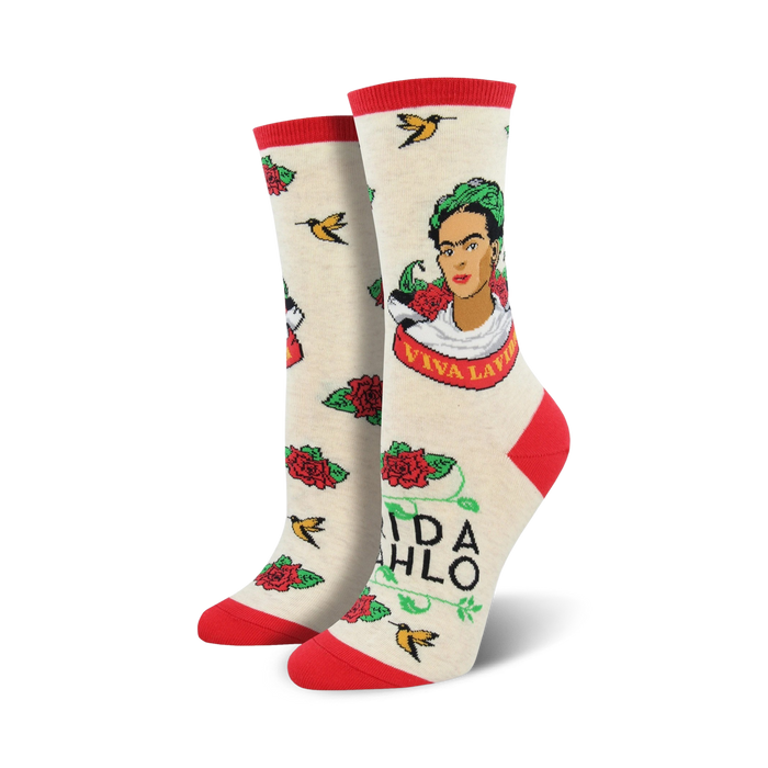 Cream crew socks with a Frida Kahlo portrait, red roses, hummingbirds, and 'Viva La Vida' text. Red and green accents.