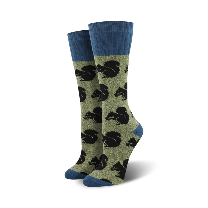 Pair of olive green crew socks with navy blue cuffs. All-over print features black silhouettes of squirrels. }}