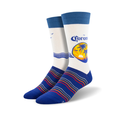 Pair of crew socks; predominantly white with a Corona beer logo featuring a palm tree sunset; blue stripes at the bottom; blue cuffs.
